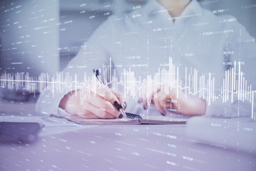 Financial chart drawn over hands taking notes background. Concept of research. Multi exposure