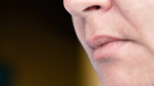 Woman smoking cigarrete and blowing the smoke out of her mouth
