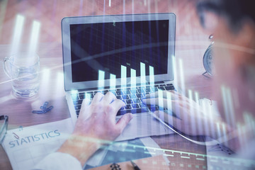 Multi exposure of forex graph with man working on computer on background. Concept of market analysis.