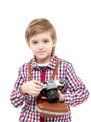 Adorable smart photographer kid holding black camera in hands looking at camera on white background