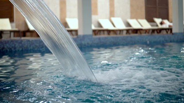 Empty luxury pool with waterfall jet