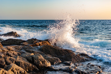 waves breaking in a breeze on a stone coast
