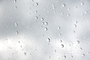 Rain drops with selective focus on transparent glass. Glass surface with water drops. Window with raindrops. water drops on glass. Rainy autumn weather