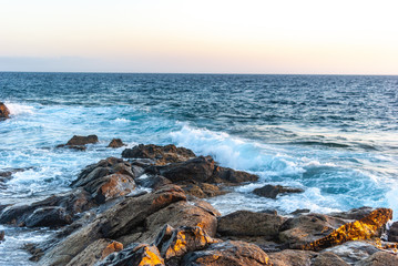 waves cover a stone coast