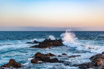 evening sky over the ocean and blue waves