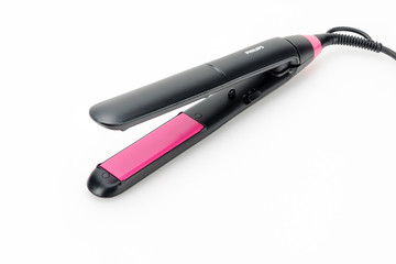 Hair iron on white mat background with copy space