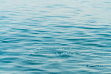 Ripples on surface of blue water background