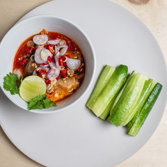 Salad with sardines in tomato sauce in the top corner cup