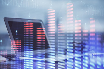 Stock market chart hologram drawn on personal computer background. Double exposure. Concept of investment.
