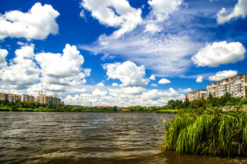 Obraz premium modern residential building and park with duck pond urban street landscape panorama view of scenic cityscape and green forest reflection in lake water panoramic wide concept