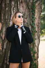 Woman in a black jacket with short gloves