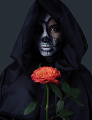 Mysterious witch with red rose