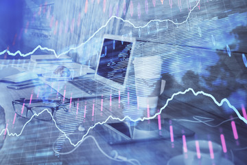 Stock market graph and table with computer background. Multi exposure. Concept of financial analysis.