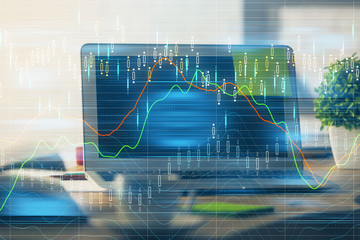 Financial graph colorful drawing and table with computer on background. Multi exposure. Concept of international markets.