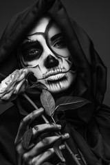 Female death with delicate rose