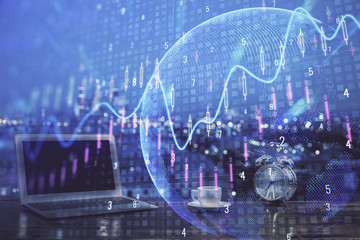 Double exposure of chart and financial info and work space with computer background. Concept of international online trading.