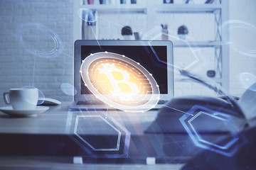 Multi exposure of blockchain theme hologram and table with computer background. Concept of bitcoin...