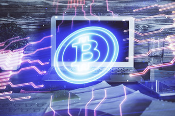 Multi exposure of blockchain theme hologram and table with computer background. Concept of bitcoin crypto currency.