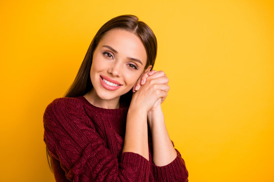 Photo of nicely looking kind cute girl having laid her head onto her hands staring into camera while isolated with yellow background