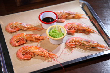 Langoustines with sauce on a tray.