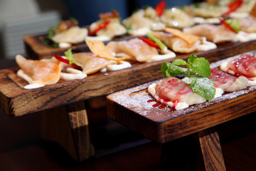 Dumplings with potato in sour cream on a wooden board.  Dumplings with mushrooms. Dumplings with cherries.