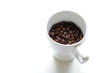 A cup is filled with coffee grains instead of a drink.