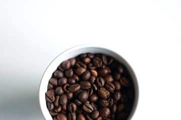Part of a bowl with coffee grains.