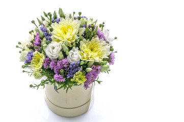 Naklejka na ściany i meble Bouquet of flowers in a round gift box on a white background. Great Gift for Wedding, Birthday, Valentine's Day or Mother's Day. Copy space