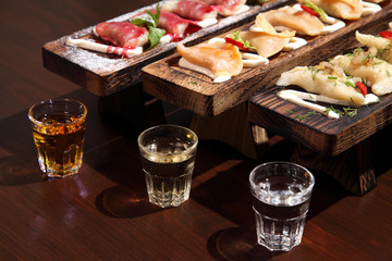 Dumplings with potato in sour cream on a wooden board.  Dumplings with mushrooms. Dumplings with cherries.