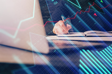 Double exposure of businessman with laptop and stock market forex chart.