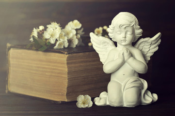 Sympathy card with guardian angel, spring flowers and old book