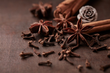 Star anise, cinnamon and dry spice cloves. Christmas spices on rustic wooden background. Close up. 