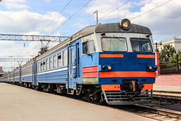 Train on railway station with sky on background