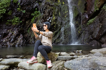woman selfie near the waterfall