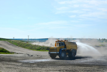 Water sprinkling vehicles are designed for performing water-sprinkling functions in open pits at opencast mining of minerals. Water truck watering the ground to moisten dust.  Water tank truck
