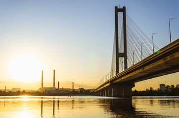 South bridge, Kyiv, Ukraine. Kyiv bridge over the Dnipro river against the backdrop of a beautiful sunset. The bridge in the evening sun
