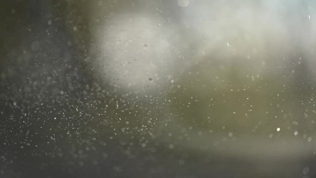 Windshield wipers in slow-motion clearing car windscreen