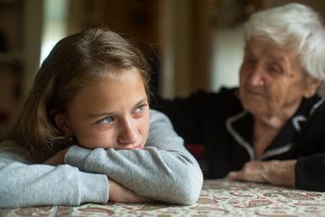 Little cute girl sad and grandmother soothes her.