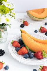 Fruit and berries on white wooden table