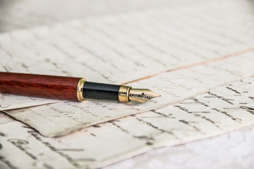 fountain pen lies on manuscript from old paper