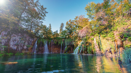 panoramic waterfalls in autumn with crystal clear lake 