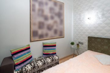 Modern interior of bedroom in studio apartment. King-size bed.