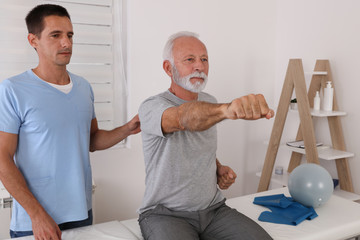 Senior man Kinesiology treatment, Physical therapy. Patient and terapist