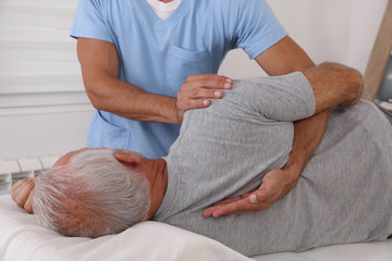 Chiropractic / Osteopathy treatment, Back pain relief. Physiotherapy for senior male patient,...