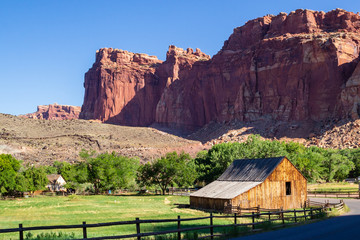 Beautiful canyon red rocks and Gifford barn at the farm at the Fruita Oasis in Capitol Reef...
