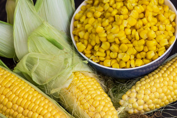 Boiled corn in a bowl. Raw Corn with Green Leaves