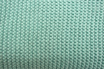 Knitted background green, yarn texture close-up