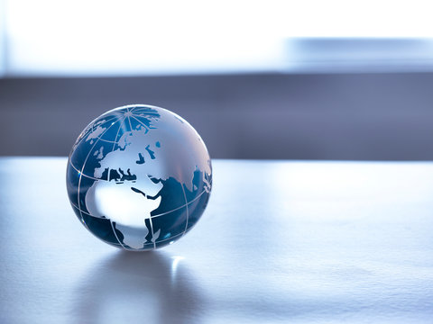 Global Markets, A glass globe illustrating the world on a desk.