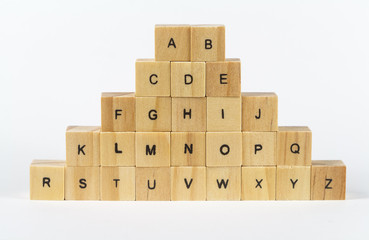 Alphabet letters written on wooden cubes