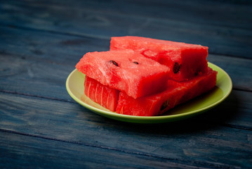 Juicy watermelon in a salad plate, on a stylish background.